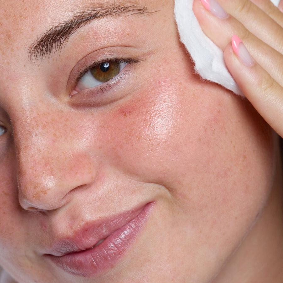 Model applying 5% Citrus Fruit & Glycolic Glow Toner on her face