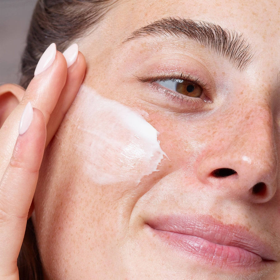 Model applying Citrus-C Mask & Daily Moisturizer on her cheek