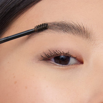 model applying on Stylus Eyebrow Pencil & Gel in shade ash brown