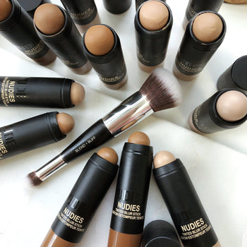 Flat lay of Blend & Buff Foundation Brush surrounded by Nudesttix products