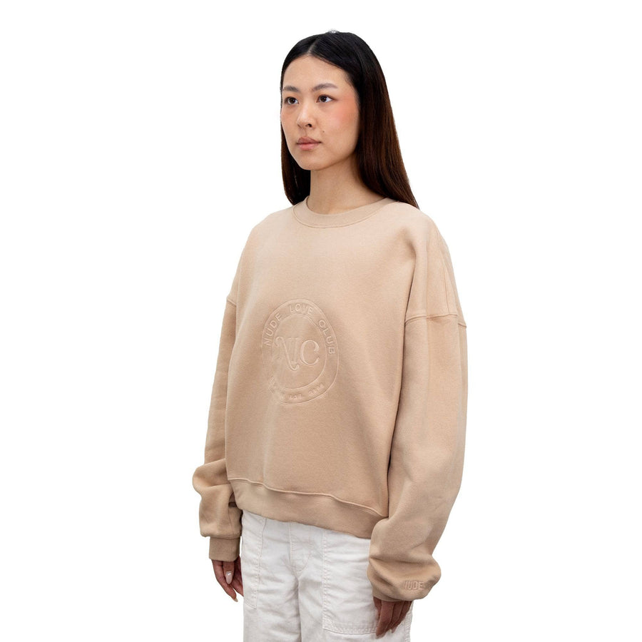 NUDE LOVE CLUB EMBLEM CREWNECK TAN angled view