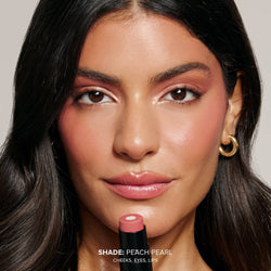Young woman wearing Nudies Matte Glow Core in shade Peach Pearl