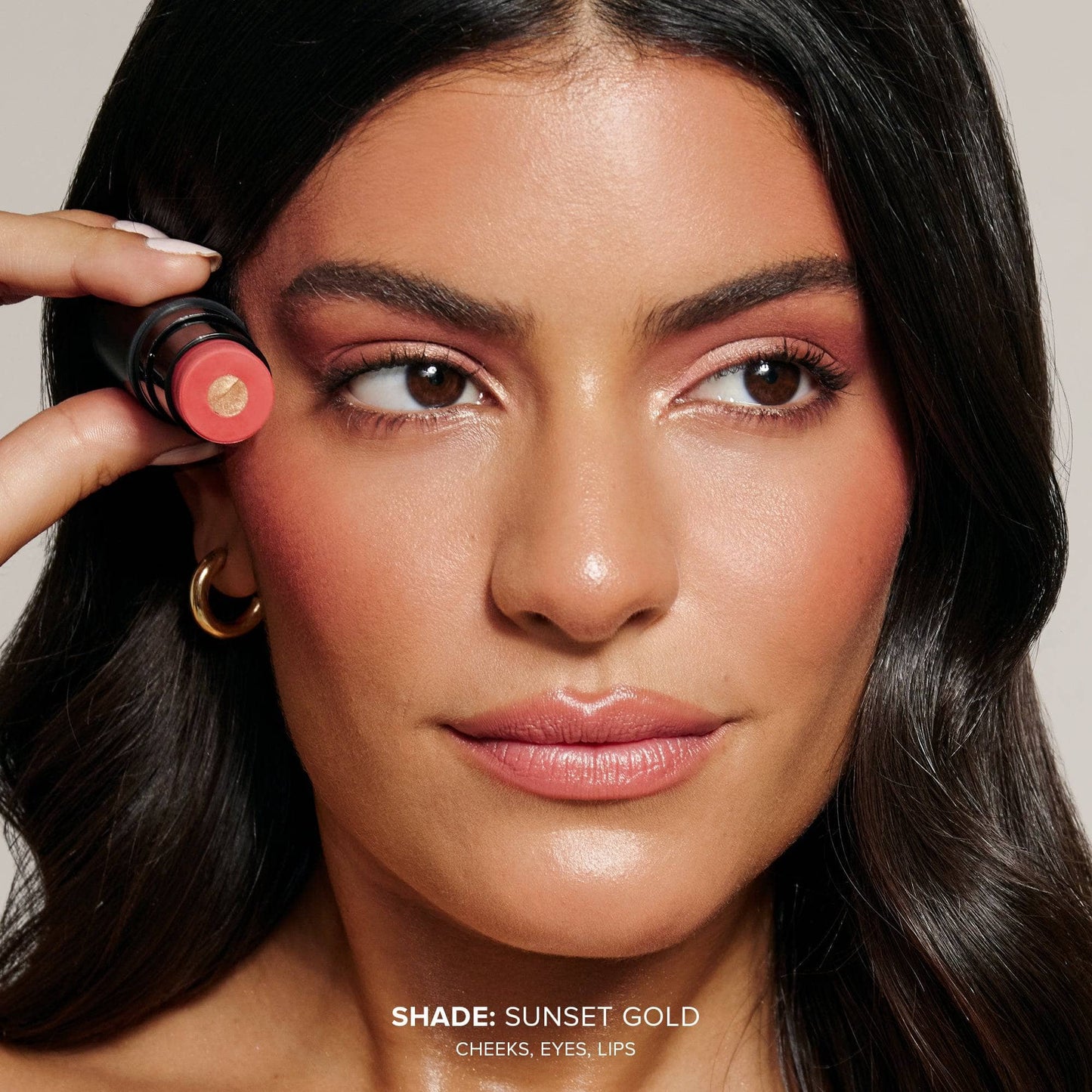 Young woman wearing Nudies Matte Glow Core in shade Sunset Gold