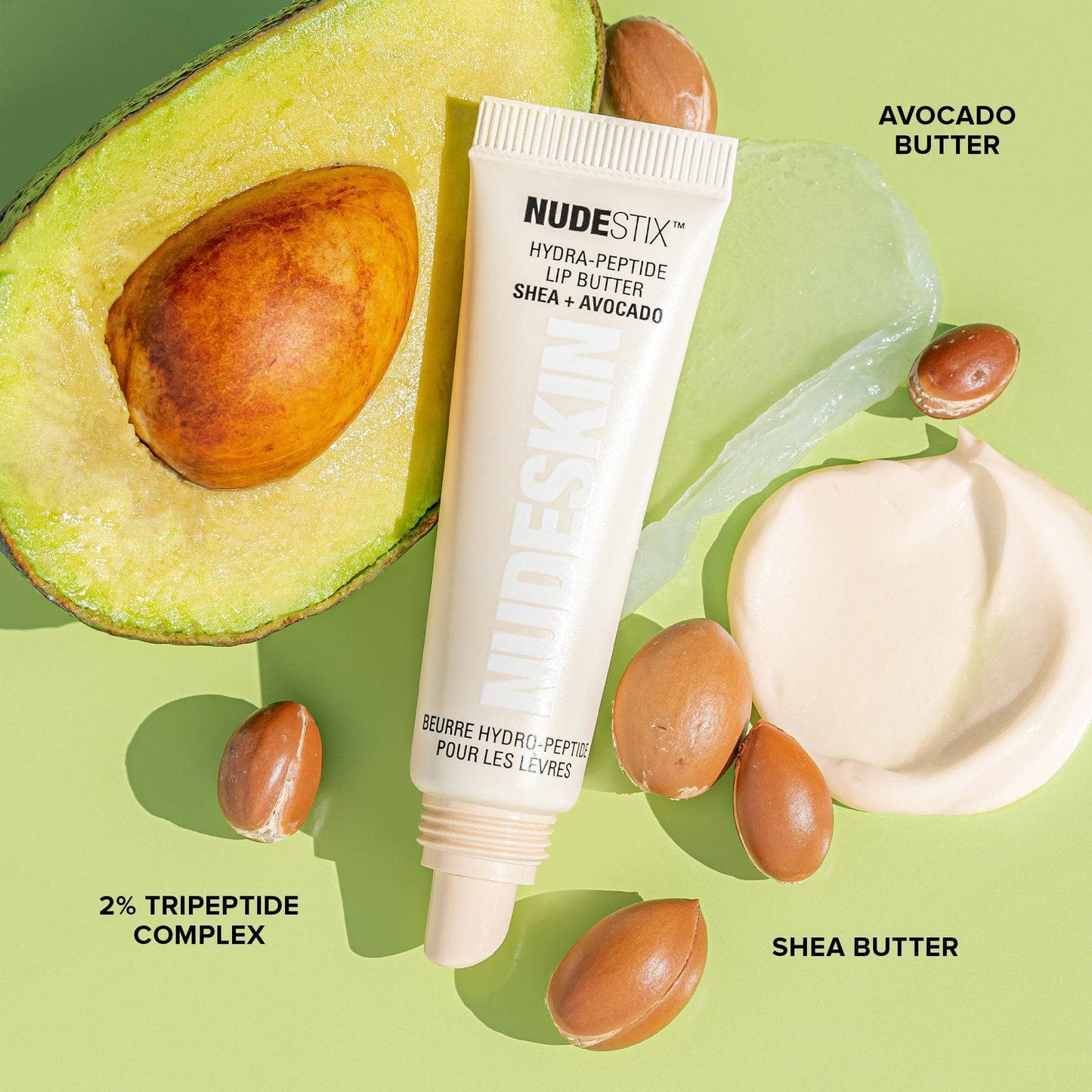 Hydra-Peptide Lip Butter Candy Kiss. Flat lay with avocado and shea butter