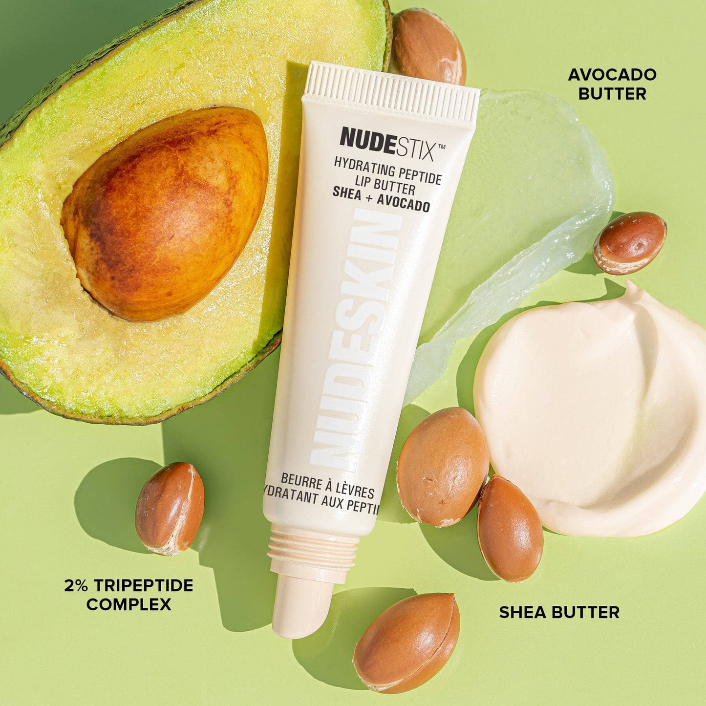 Hydra-Peptide Lip Butter Sugar Plum. Flat lay with avocado and shea butter