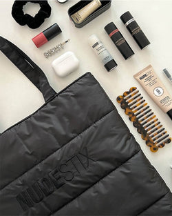 Nude Puff Tote flat lay with Nudestix products around