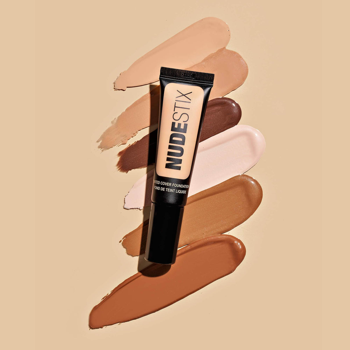 Tinted Cover Liquid Foundation Nude 1.5 with texture swatches behind