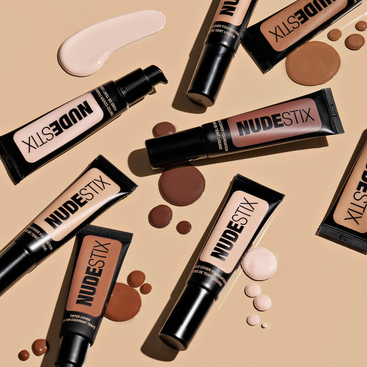 Flat lay of Tinted Cover Liquid Foundation nude 10 and other shades