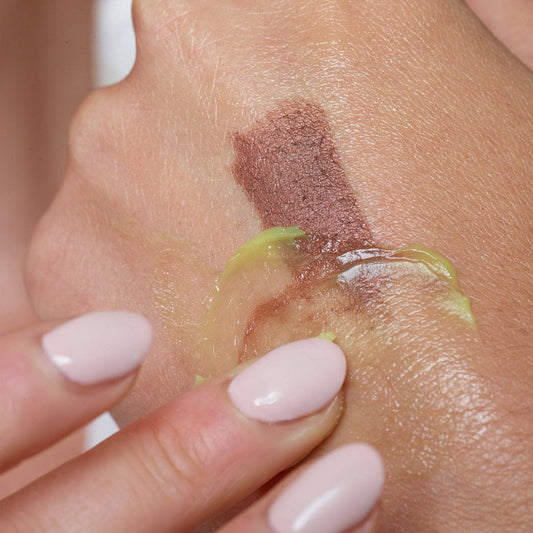 Hands removing makeup from the back of a hand with CITRUS CLEAN BALM & MAKE-UP MELT