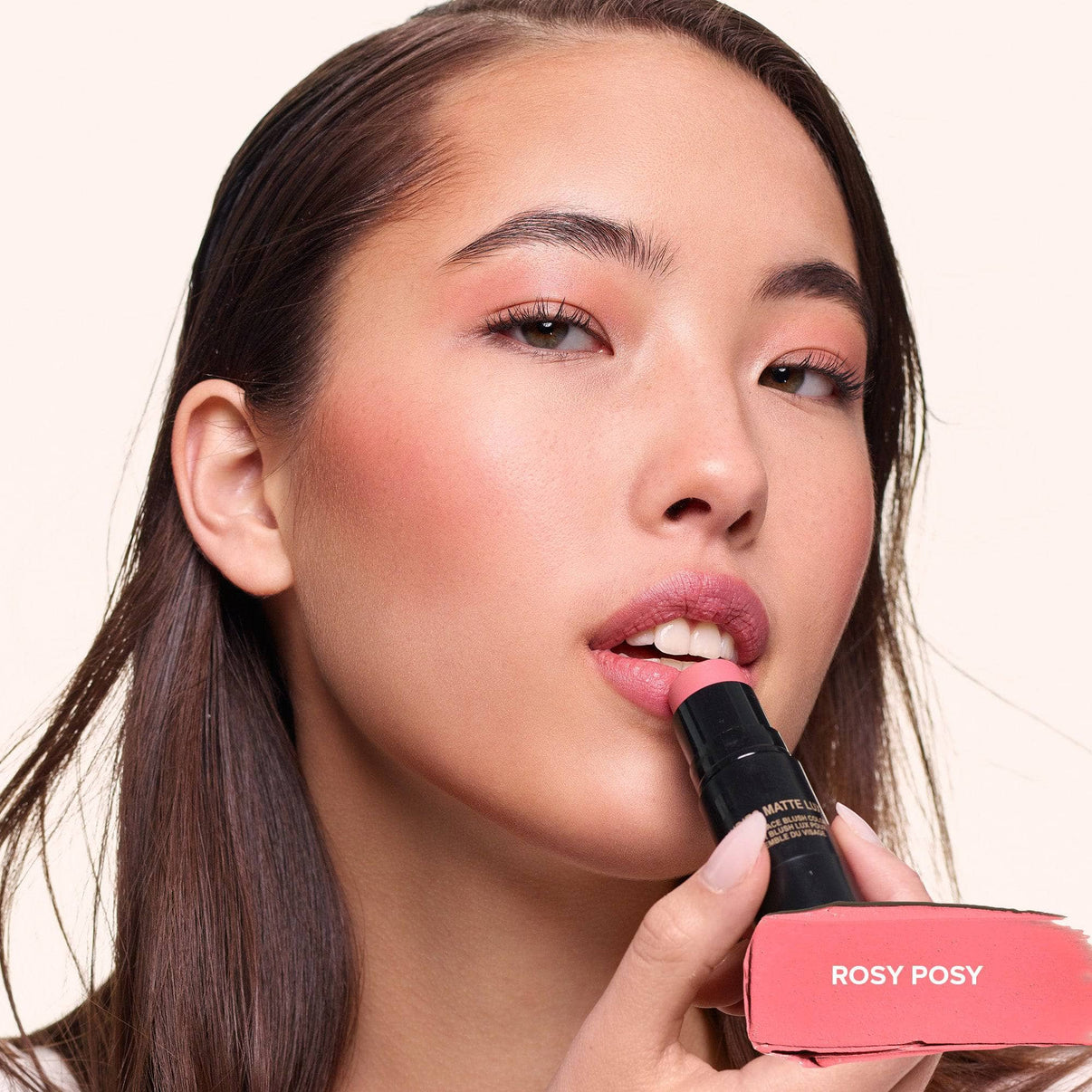 Young woman applying Nudies Matte Lux in shade Rosy Posy on her lips - 7