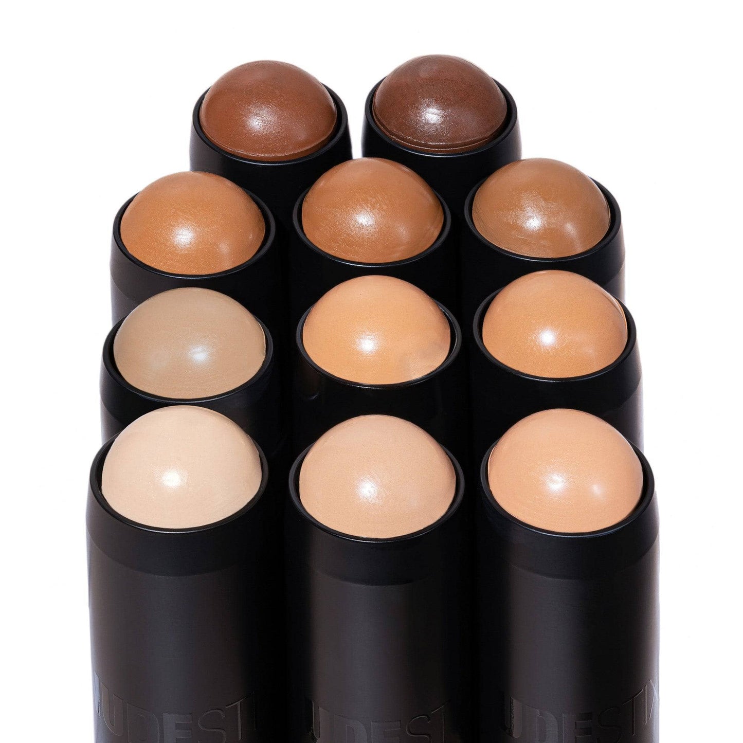 deep 9.5 standing with other Tinted Blur Foundation Stick shades