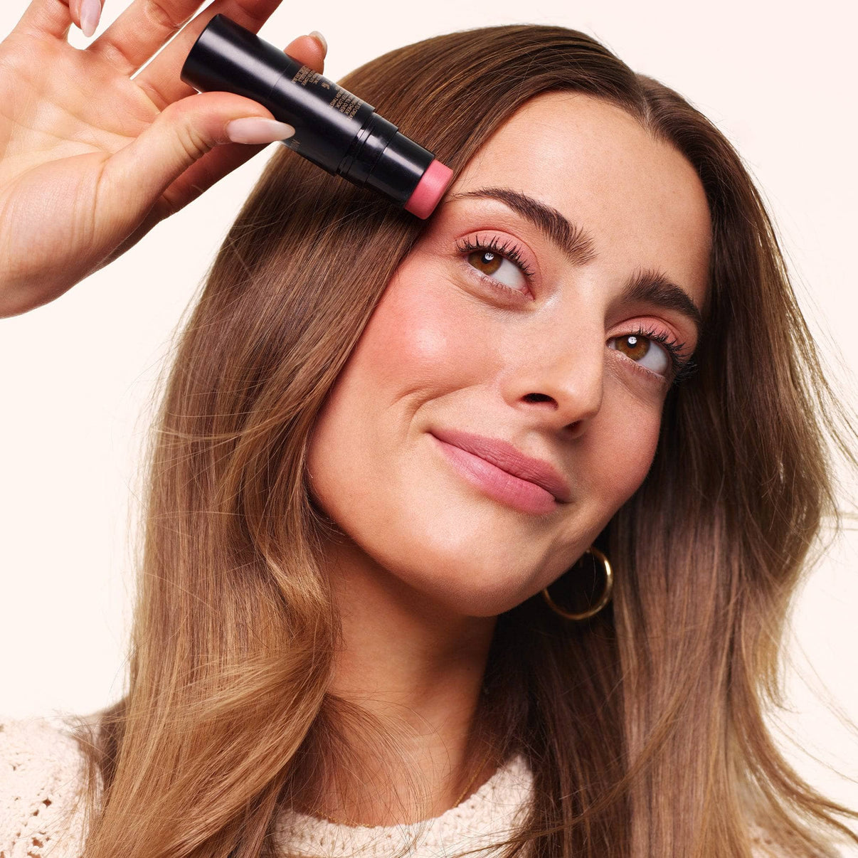 Taylor Frankel holding Nudies Matte Lux in shade Rosy Posy-2