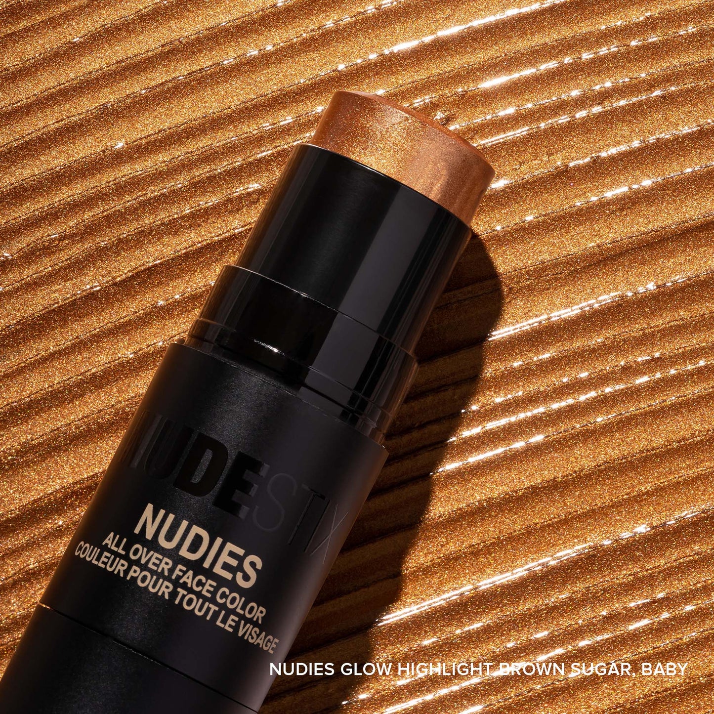 Nudies Glow highlighter in shade Brown Sugar Baby with texture swatch