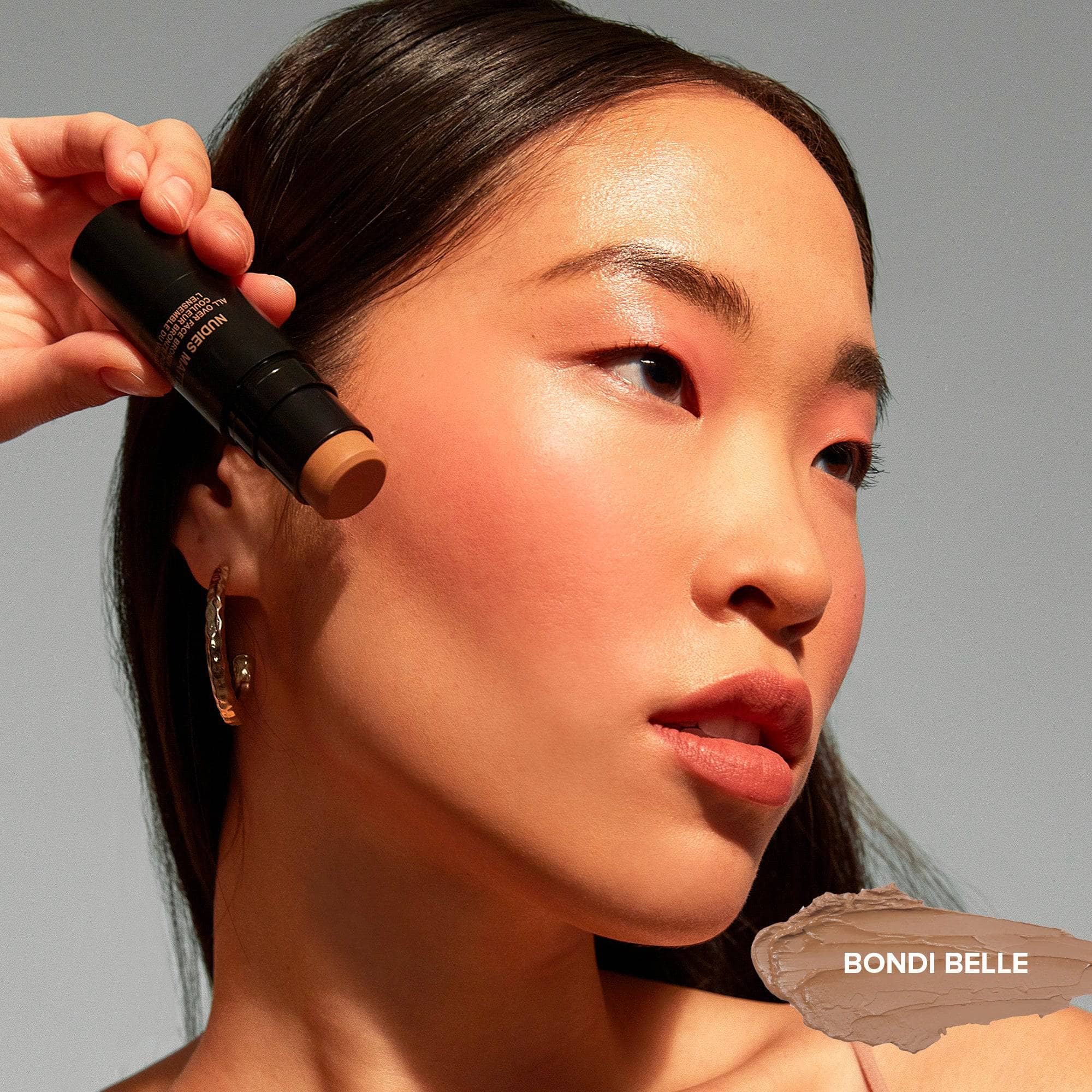 Asian young woman wearing Nudies Blush Stick in shade Bondi Belle