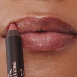 Young woman applying on Intense Matte Lip + Cheek pencil in shade belle