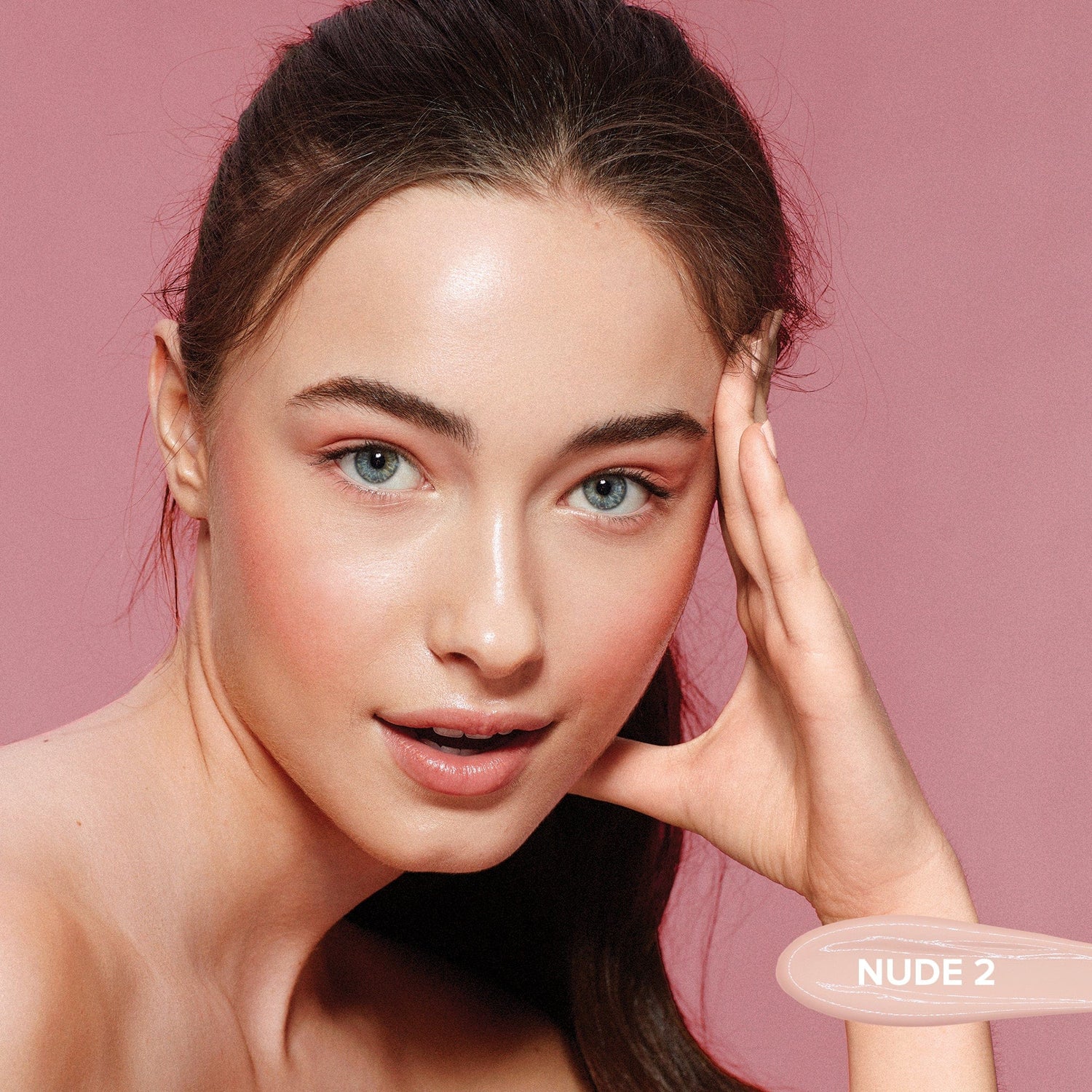 Light skinned young woman wearing Tinted Cover Liquid Foundation in shade Nude 2