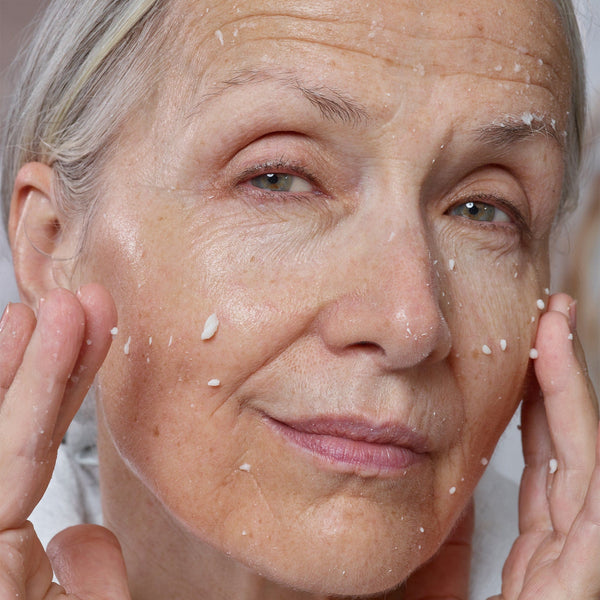 Mature woman applying LEMON-AID DETOX & GLOW MICRO-PEEL
