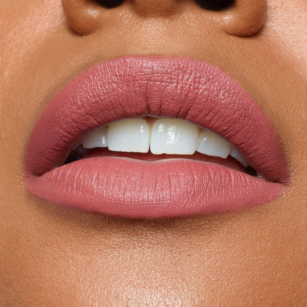 Dark skinned lips wearing Intense Matte Lip + Cheek pencil in shade purity