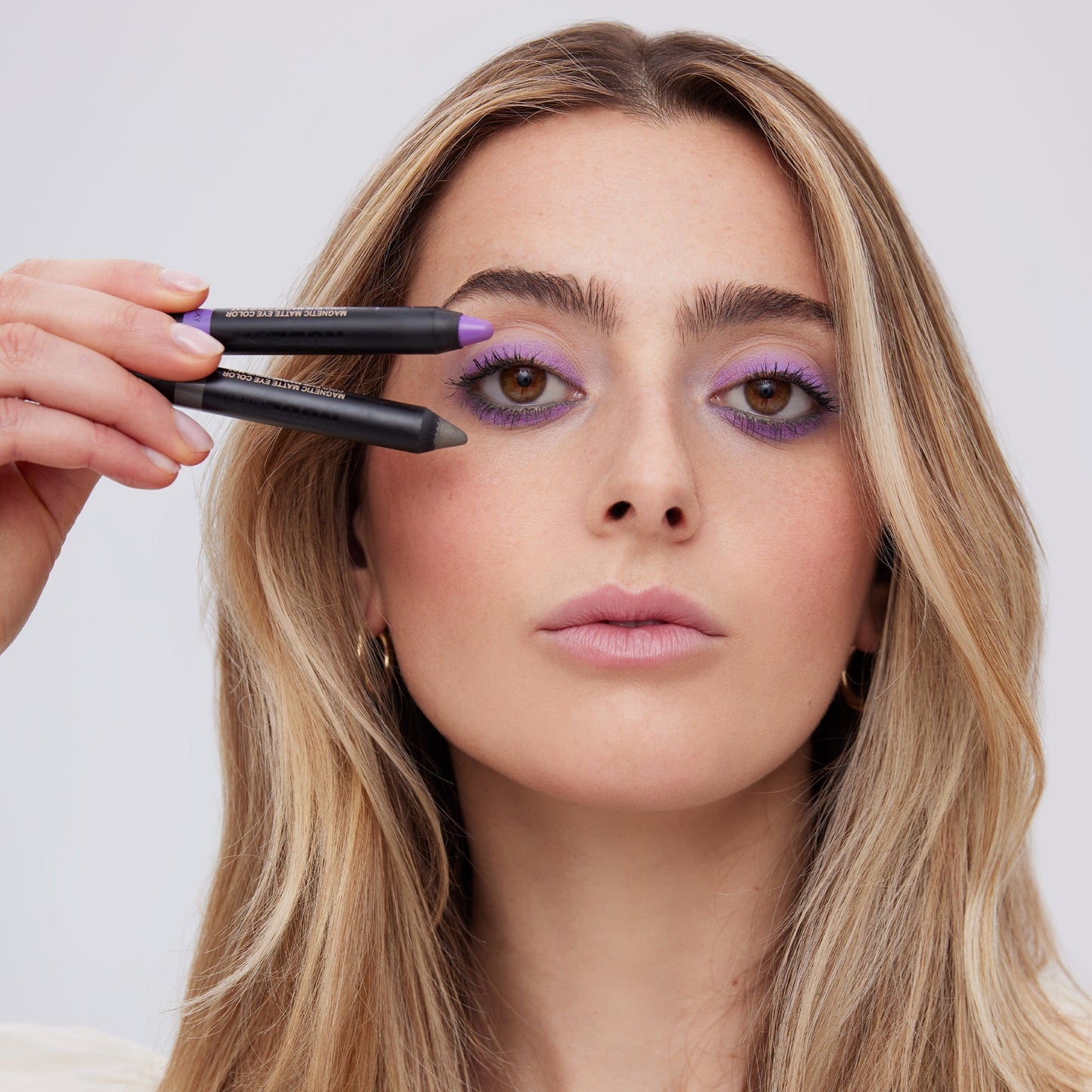 Young woman applying on Magnetic Eye Color in shade Lilac Sky - 127