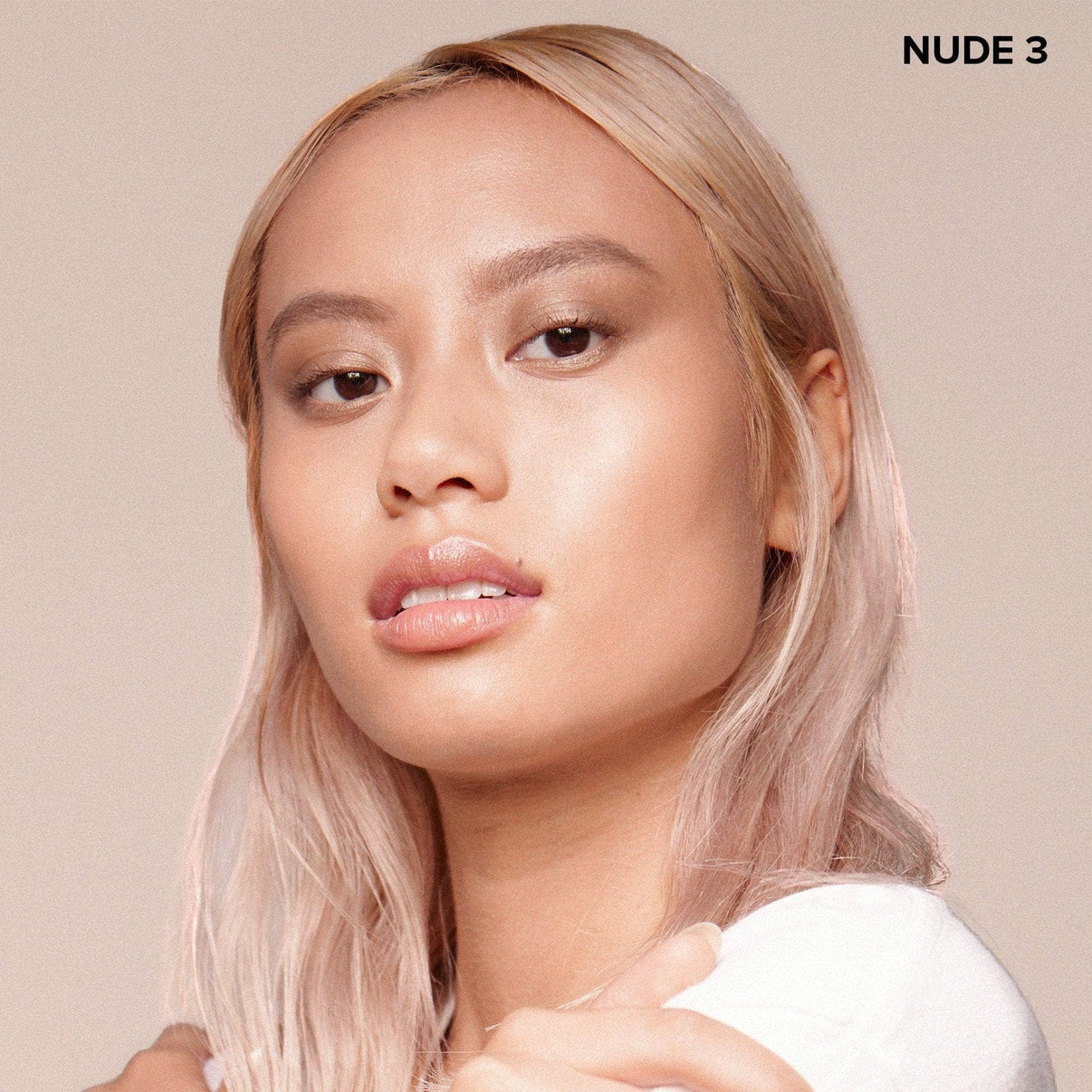 young woman wearing Nudefix cream concealer in shade nude 3